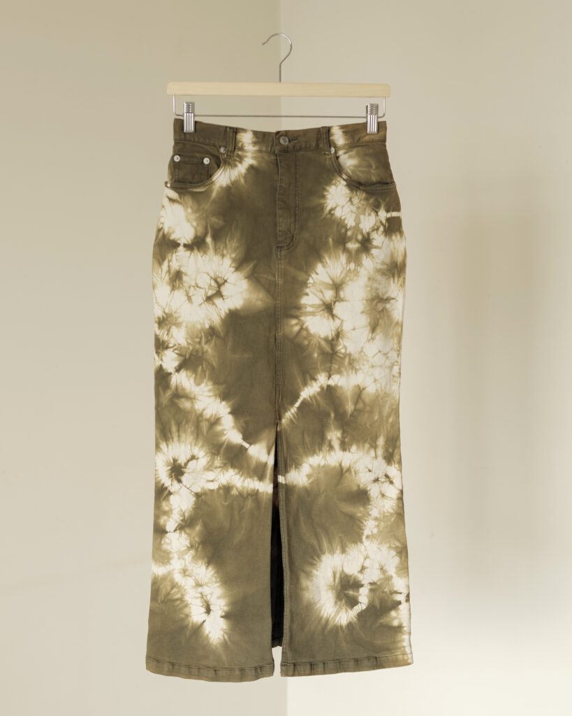 Tie-dye midi skirt with slit in muted tones and midi silhouette.