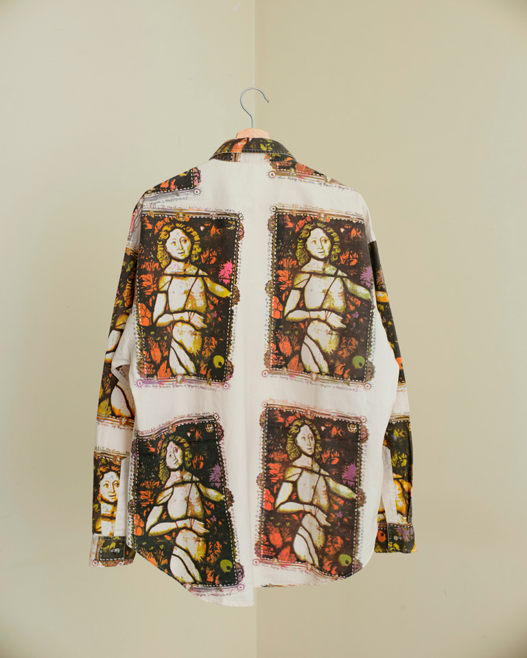 Back view of unisex long sleeve shirt featuring vintage art-inspired prints in multicolored earthy tones.