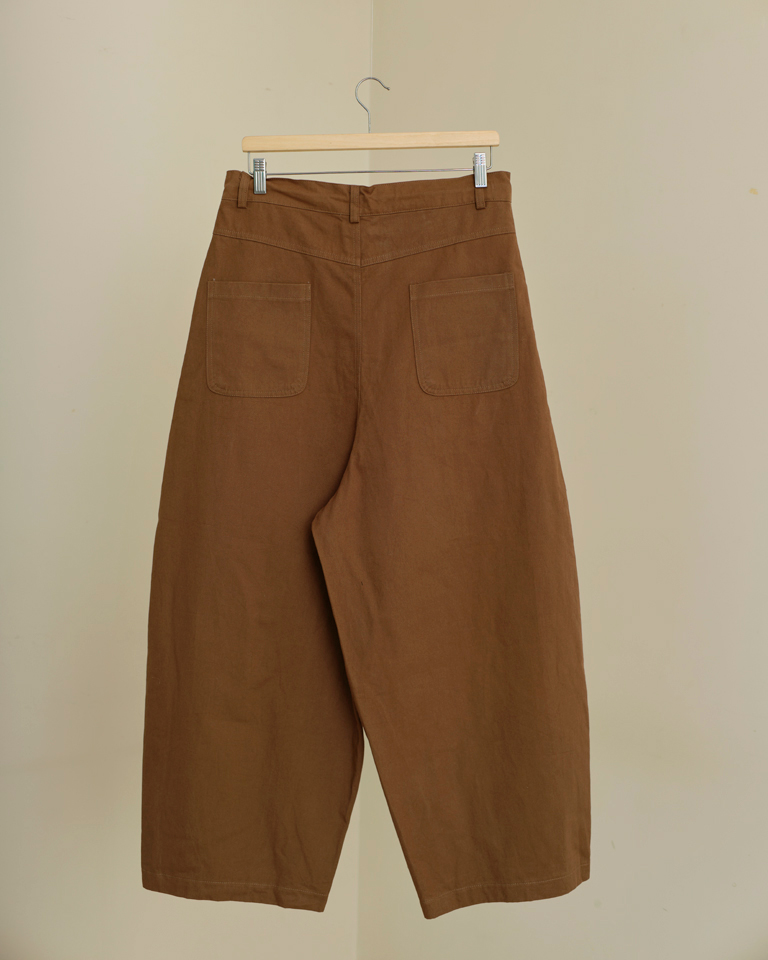 Unisex brown wide-leg balloon pants by Now + Thenn with drawstring waist and relaxed oversized fit.
