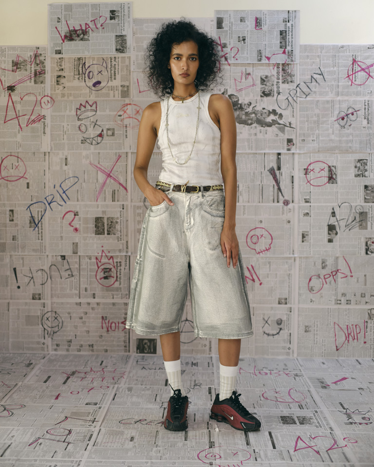 Unisex light gray washed denim carpenter shorts with knee-length wide legs, slanted pockets, and dragon embroidery on the back pocket