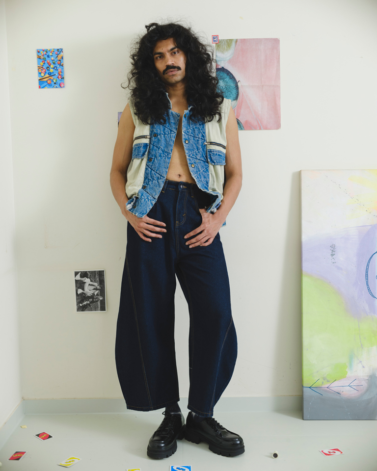 Upcycled vintage denim utility vest by Now + Thenn featuring contrast patchwork panels, zip pockets, snap buttons and elastic hem in a unisex sleeveless jacket design.