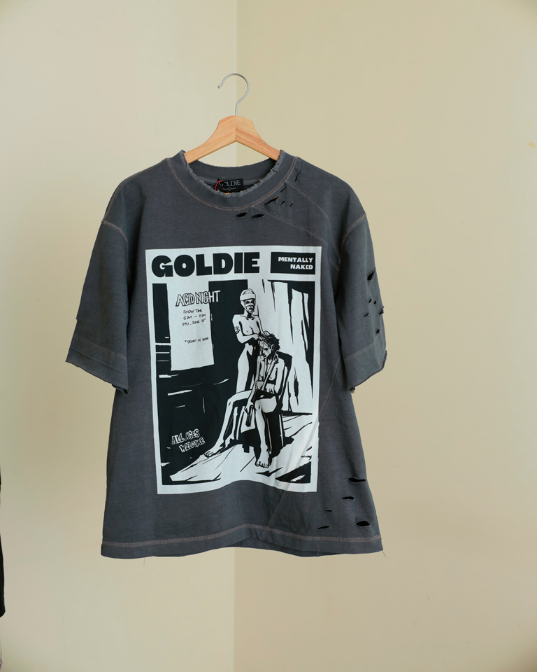 Grey oversized distressed graphic t-shirt with punk text print and front illustration, streetwear style by Now + Thenn.