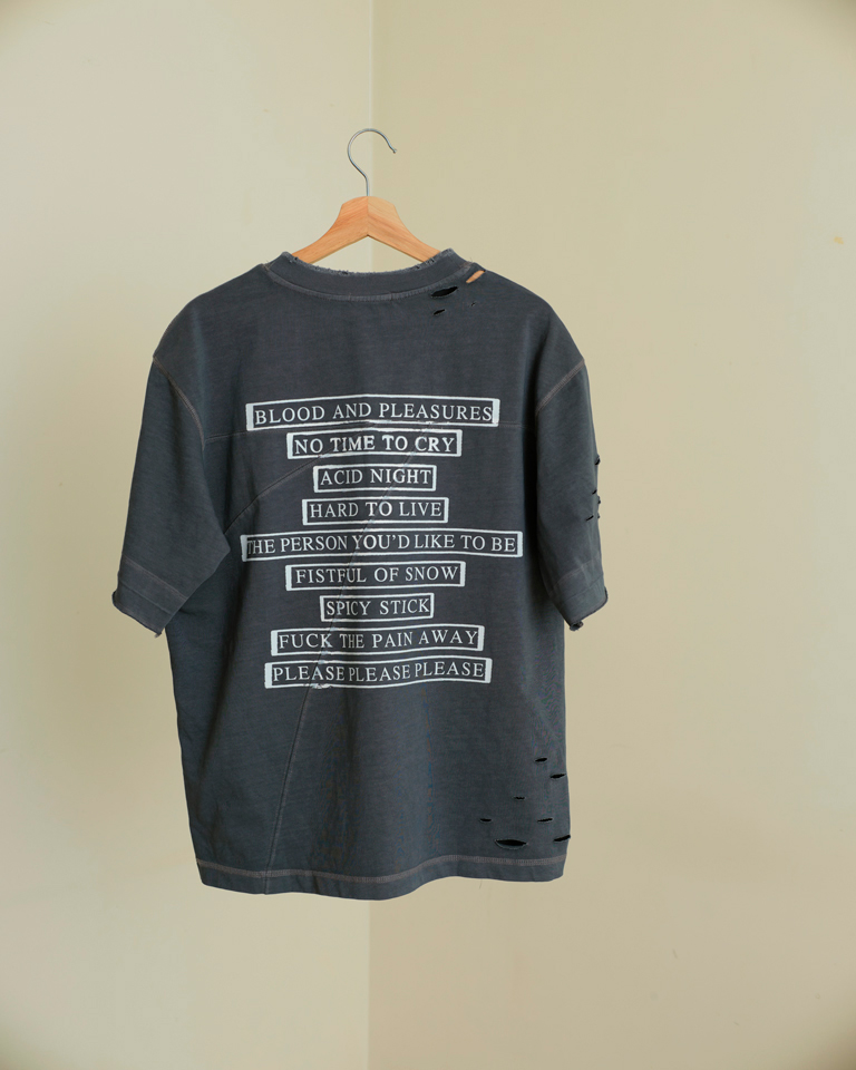 Grey oversized distressed graphic t-shirt with punk text print and front illustration, streetwear style by Now + Thenn.