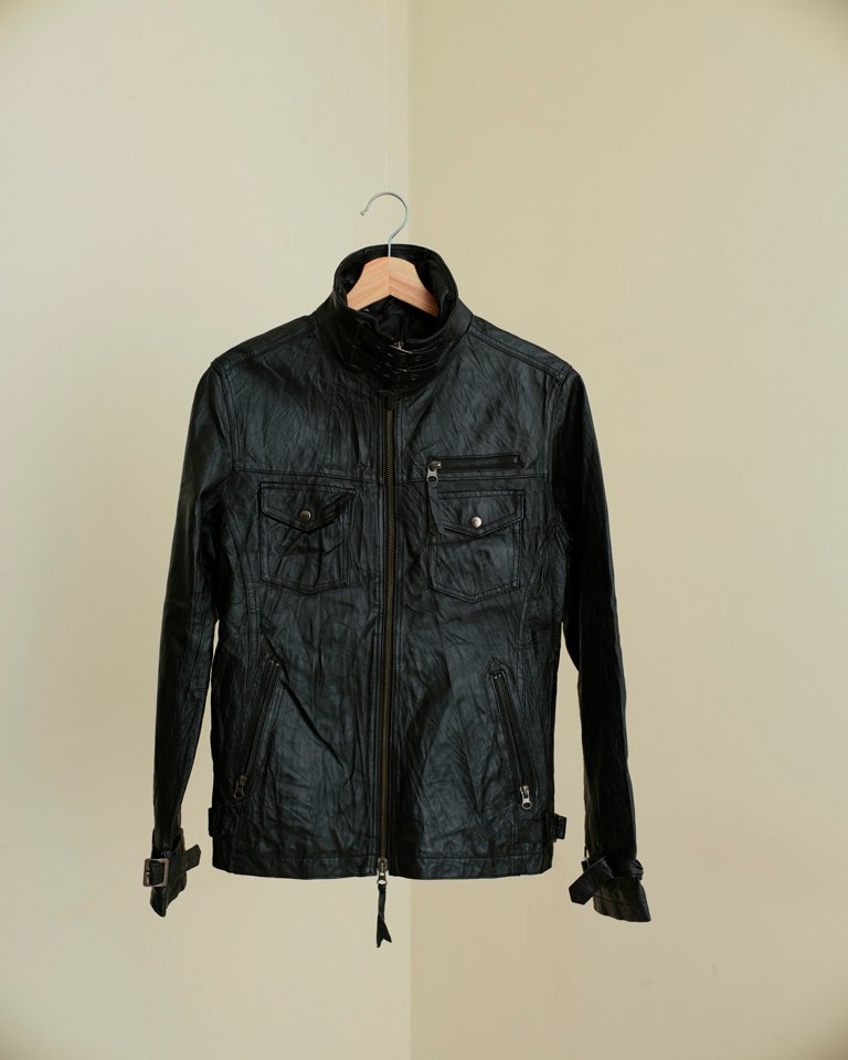 Black leather biker jacket with zip front, utility pockets and slim fit silhouette by Now + Thenn.