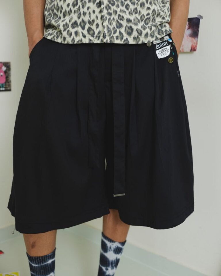Black upcycled jorts with wide legs, front pleats, long waist tie and patchwork detailing