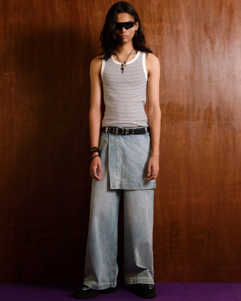 Light blue wide-leg denim jeans with integrated skirt overlay and adjustable button waist