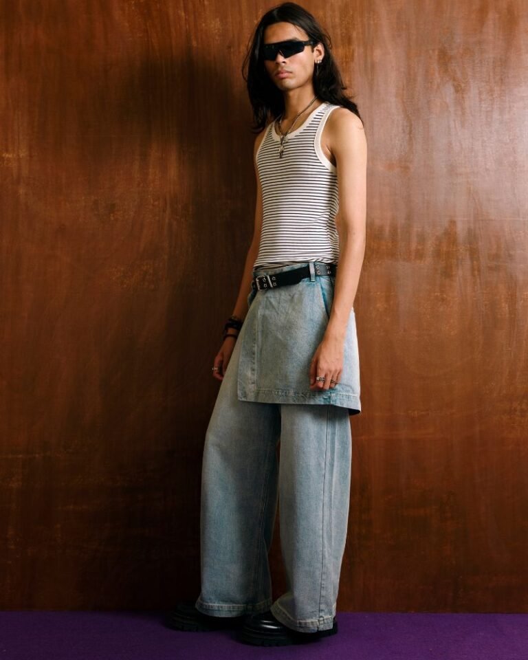 Light blue wide-leg denim jeans with integrated skirt overlay and adjustable button waist