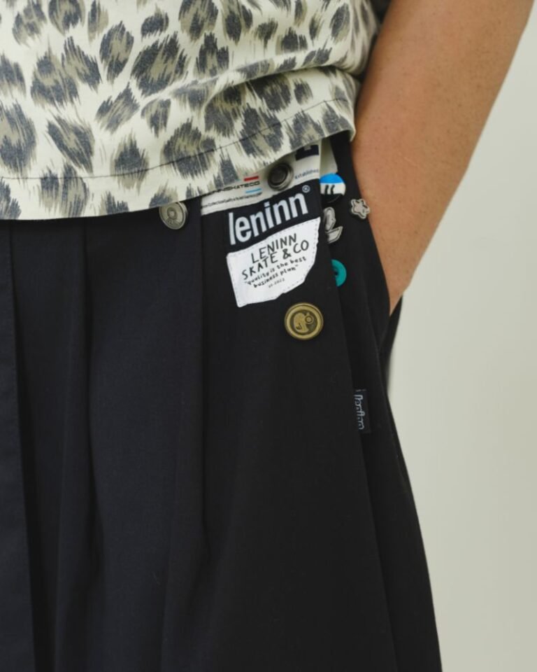 Black upcycled jorts with wide legs, front pleats, long waist tie and patchwork detailing
