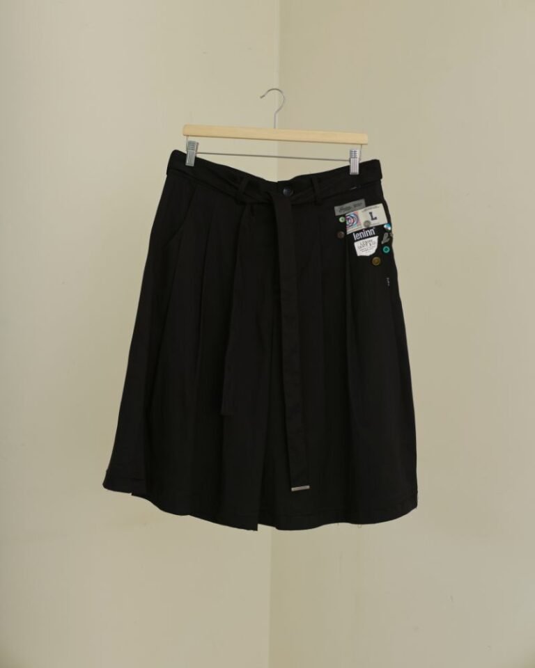 Black upcycled jorts with wide legs, front pleats, long waist tie and patchwork detailing