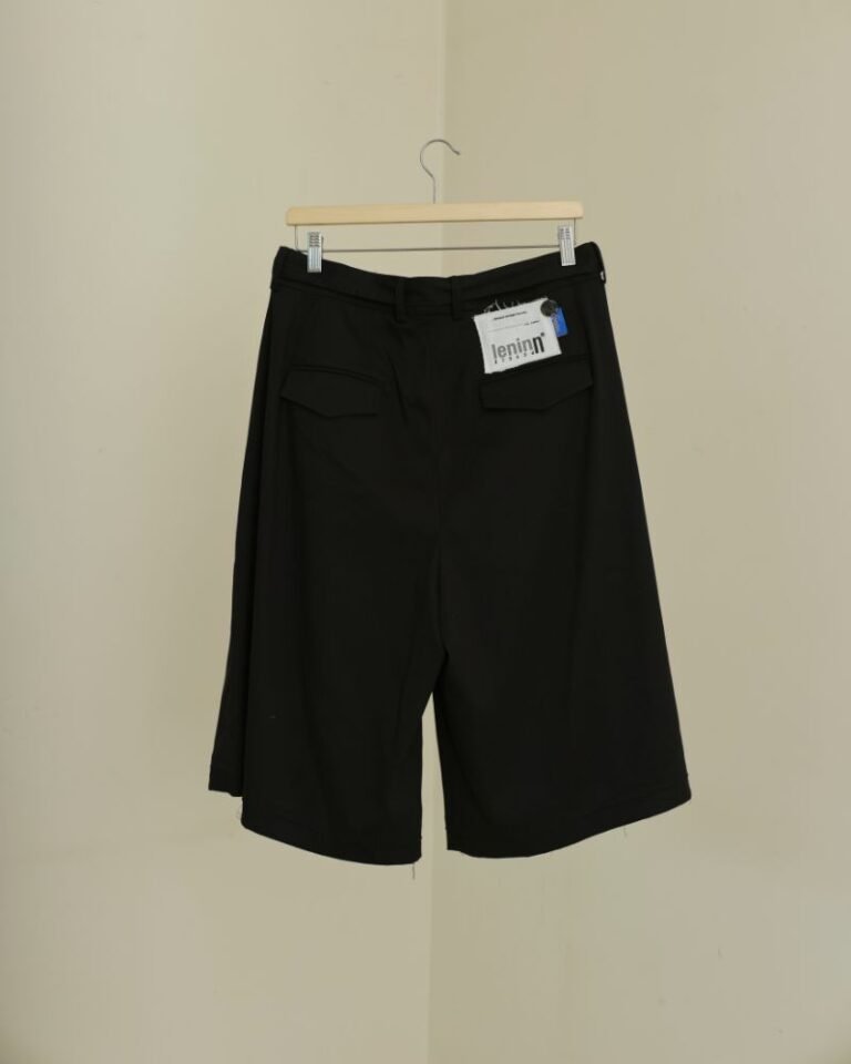 Black upcycled jorts with wide legs, front pleats, long waist tie and patchwork detailing