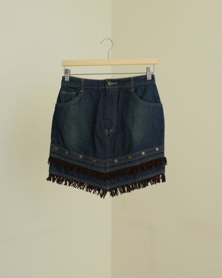 Dark denim mini skirt with layered brown suede fringe and stud detailing