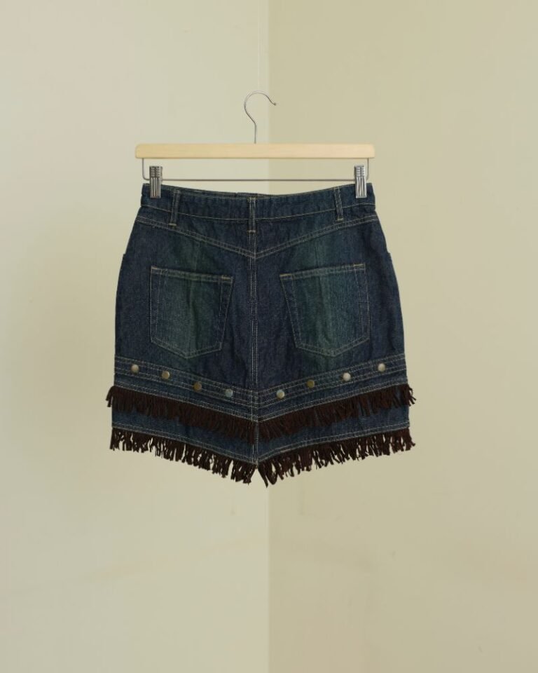 Dark denim mini skirt with layered brown suede fringe and stud detailing
