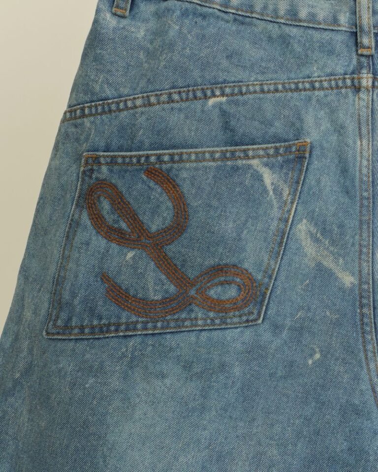 Wide-leg blue denim jorts with oversized folded hem and zip pockets