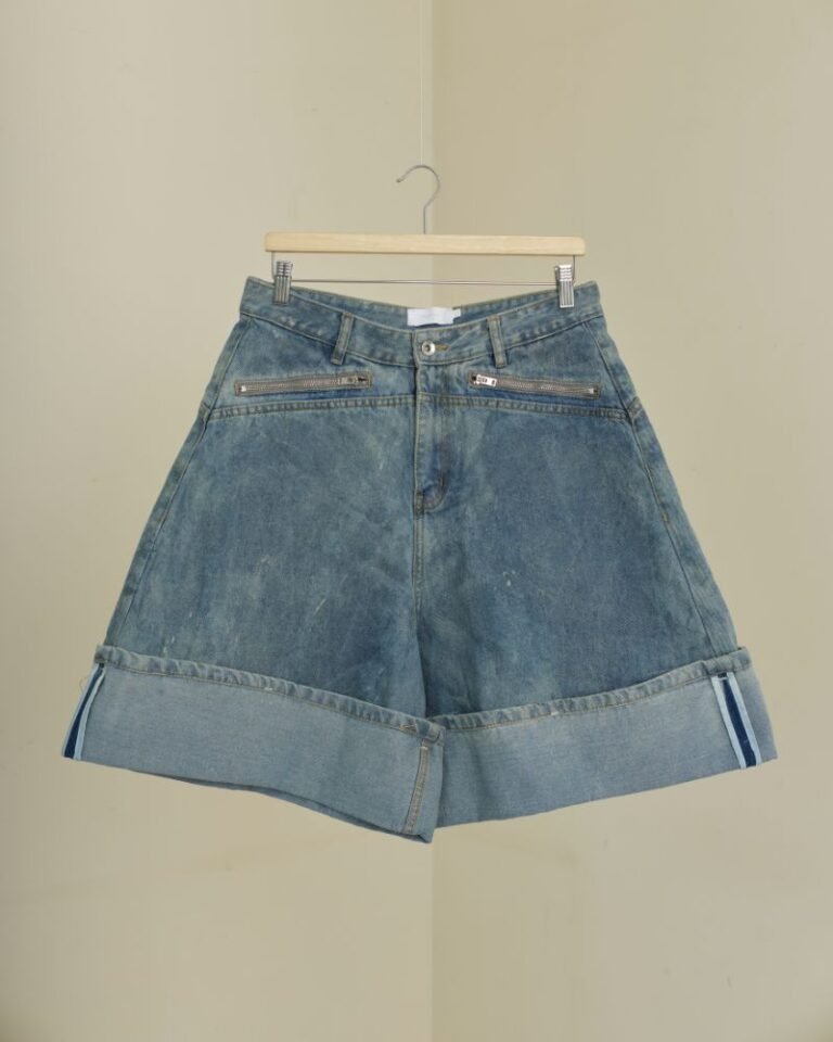 Wide-leg blue denim jorts with oversized folded hem and zip pockets