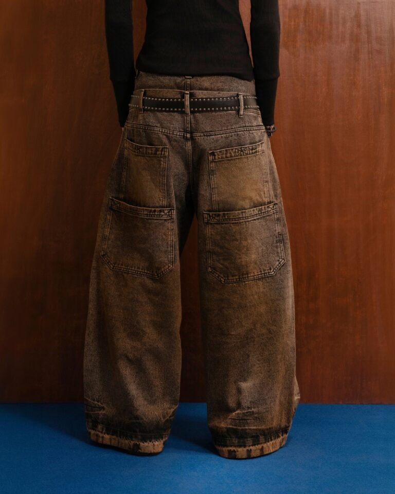 Brown and black acid mud-wash wide-leg jeans with a layered double waistband and double back pockets, shown on a hanger front and back.