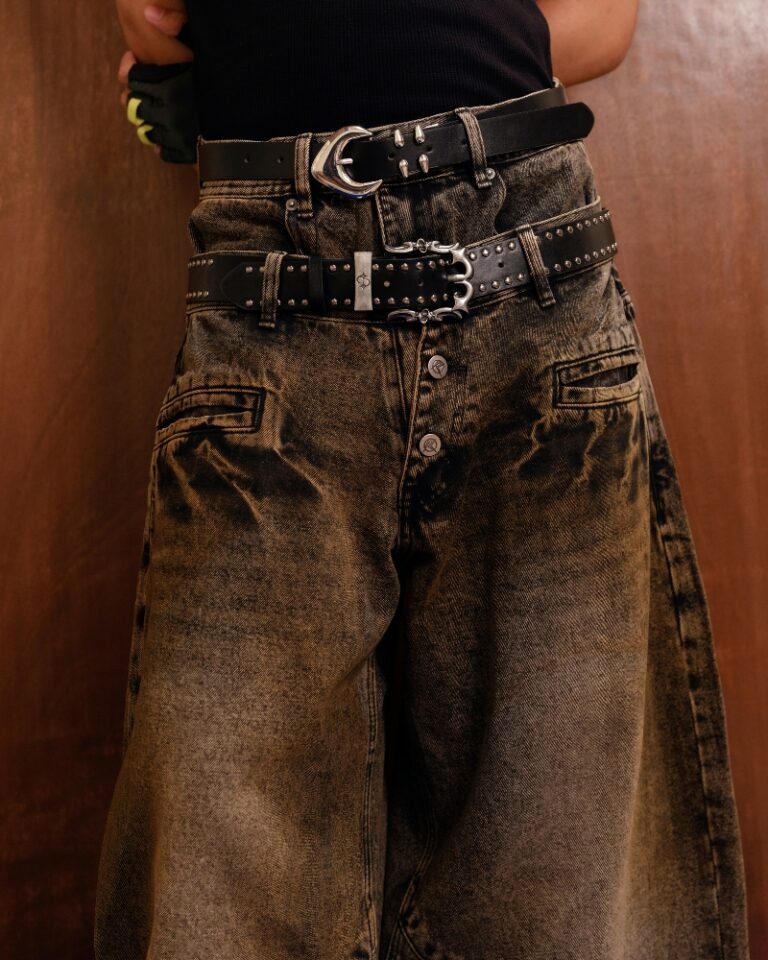 Brown and black acid mud-wash wide-leg jeans with a layered double waistband and double back pockets, shown on a hanger front and back.