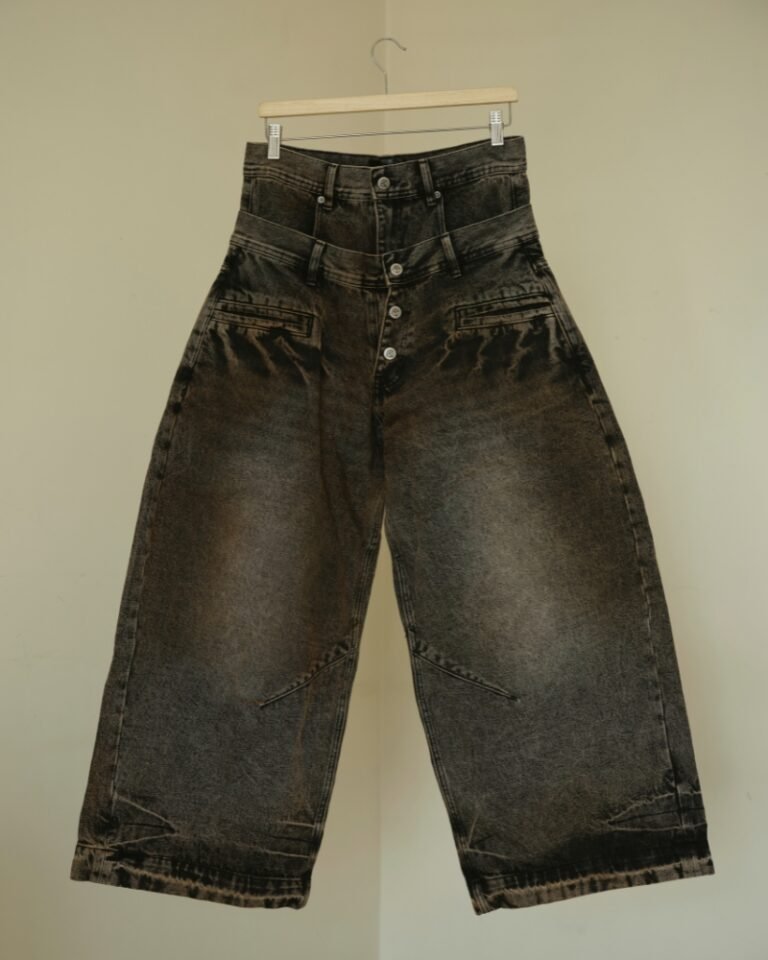 Brown and black acid mud-wash wide-leg jeans with a layered double waistband and double back pockets, shown on a hanger front and back.